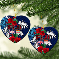 Blue heart ceramic ornament with Fiji lettering, flags, hibiscus blossoms and palm illustration.
