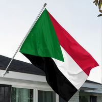 Sudan flag on pole with green, white, red and black diagonal stripe