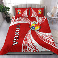 Red Tonga tapa bedding set with crest, white curved patterns, and two matching pillows