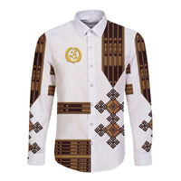 White long-sleeve button shirt with tribal geometric print and gold emblem