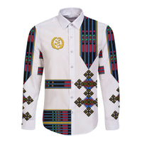 White long-sleeve button shirt, gold emblem, Eritrean pattern panels on sides