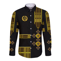 Black long-sleeve button shirt with gold graphic and geometric Ethiopian-style trim