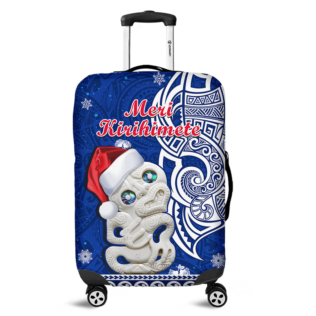 Blue Christmas luggage cover with Hei Tiki figure and “Meri Kirihimete” text, for suitcase.