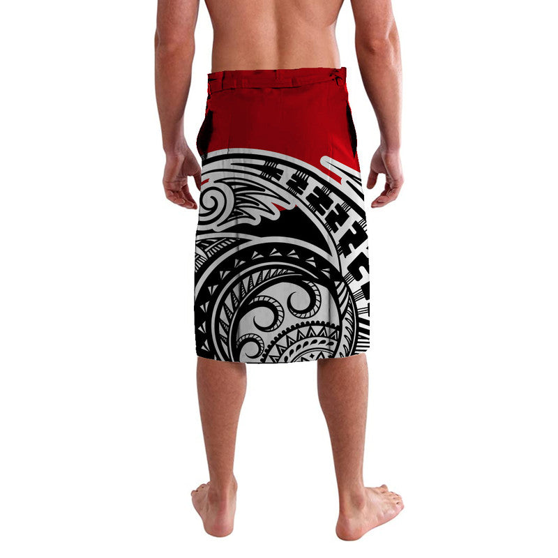 Red lavalava sarong with black-and-white tribal mask print across hem, knee-length