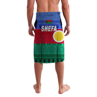 Blue lavalava skirt, front view, Shefa logo text and circular emblem over red and green pattern
