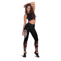 Black leggings featuring Haida-style face emblem and red/white abstract patterns
