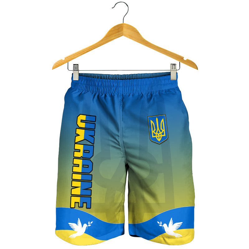 Hanging men's Ukraine flag shorts with 'UKRAINE' text, trident emblem, blue-yellow print