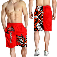 Red men’s shorts with Haida print and CANADA text, worn by model