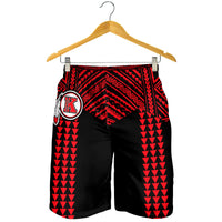 Black and red patterned swim shorts on hanger, elastic waistband, crest logo