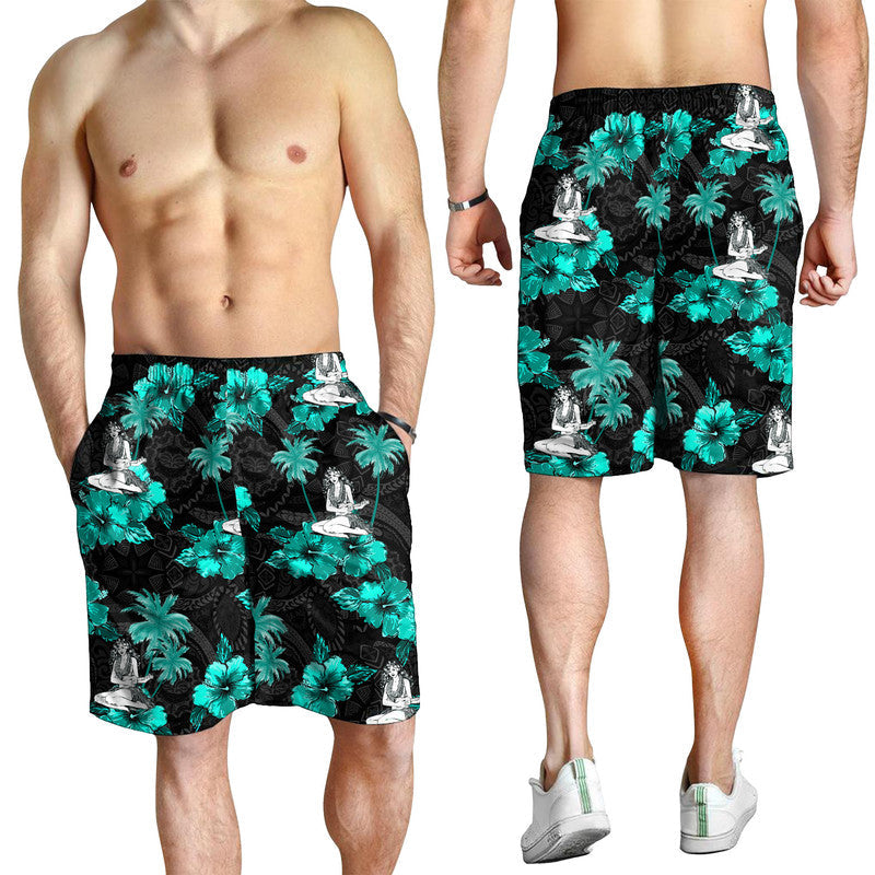 Men's black swim shorts worn by model, teal palm leaves and hula dancer pattern