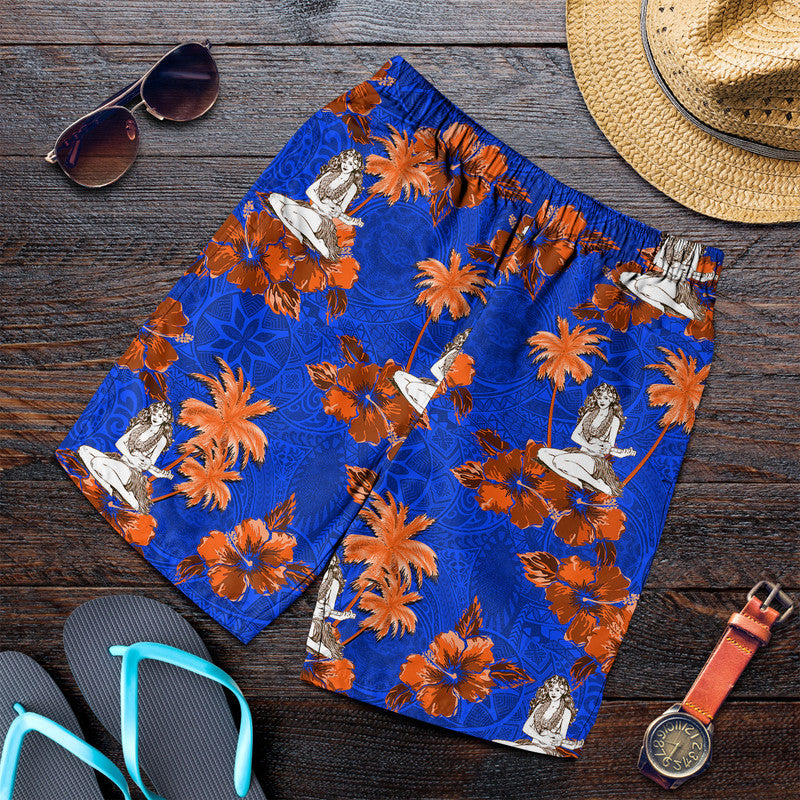 Men's blue swim shorts with orange floral print and hula dancer figures