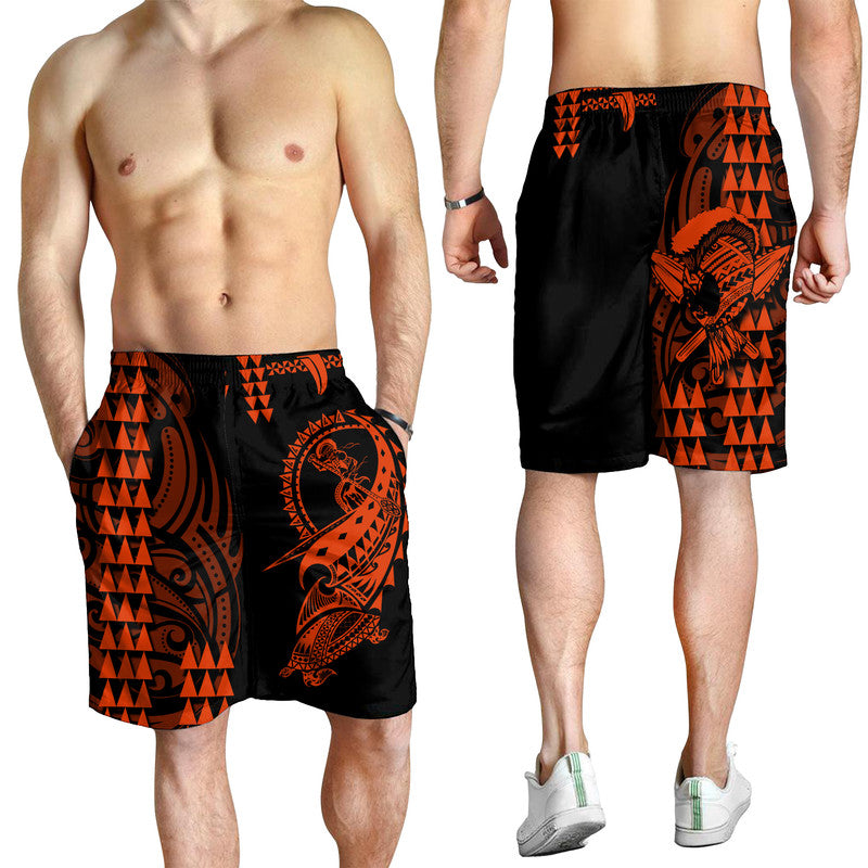 Men's black swim shorts with orange tribal warrior graphic, elastic waistband