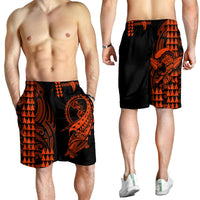 Men's black swim shorts with orange tribal warrior graphic, elastic waistband