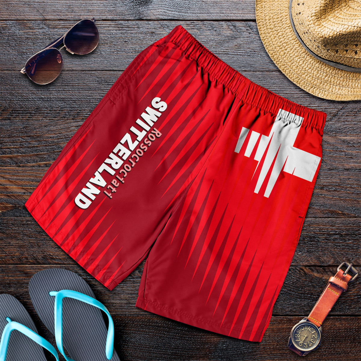 Red men’s football shorts with elastic waistband and white Swiss-style graphic