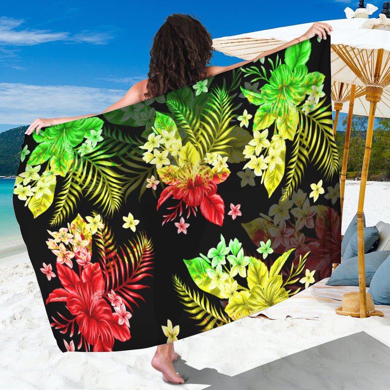 Tropical floral sarong with green, yellow, and red leaves on a dark background