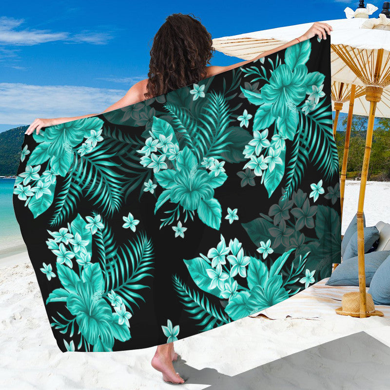Turquoise floral sarong with tropical leaf pattern on dark base, lightweight wrap
