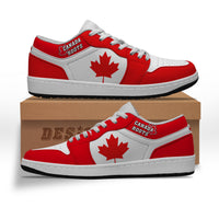 Red and white low-top sneakers with Canada Roots logo and maple leaf on side
