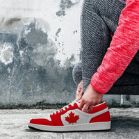 Red and white lace-up low-top sneakers, maple leaf panel and white midsole