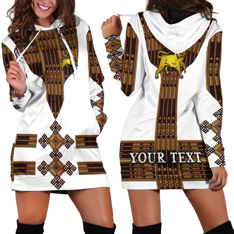 White hoodie dress with Ethiopian pattern print, hood and lion graphic, 'YOUR TEXT' front