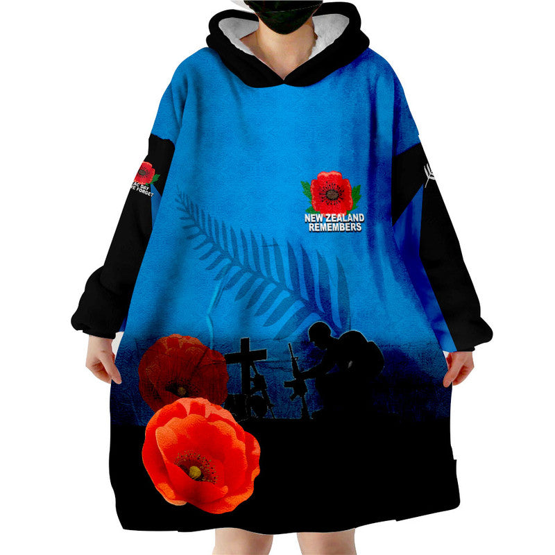 Blue wearable blanket hoodie with black hood, long sleeves, and poppy graphic print