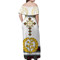 White off-shoulder maxi dress, back view with laurel tree and cross motif in gold