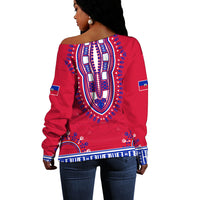 Red off-shoulder sweater back view with large blue patterned crest and border, long sleeves
