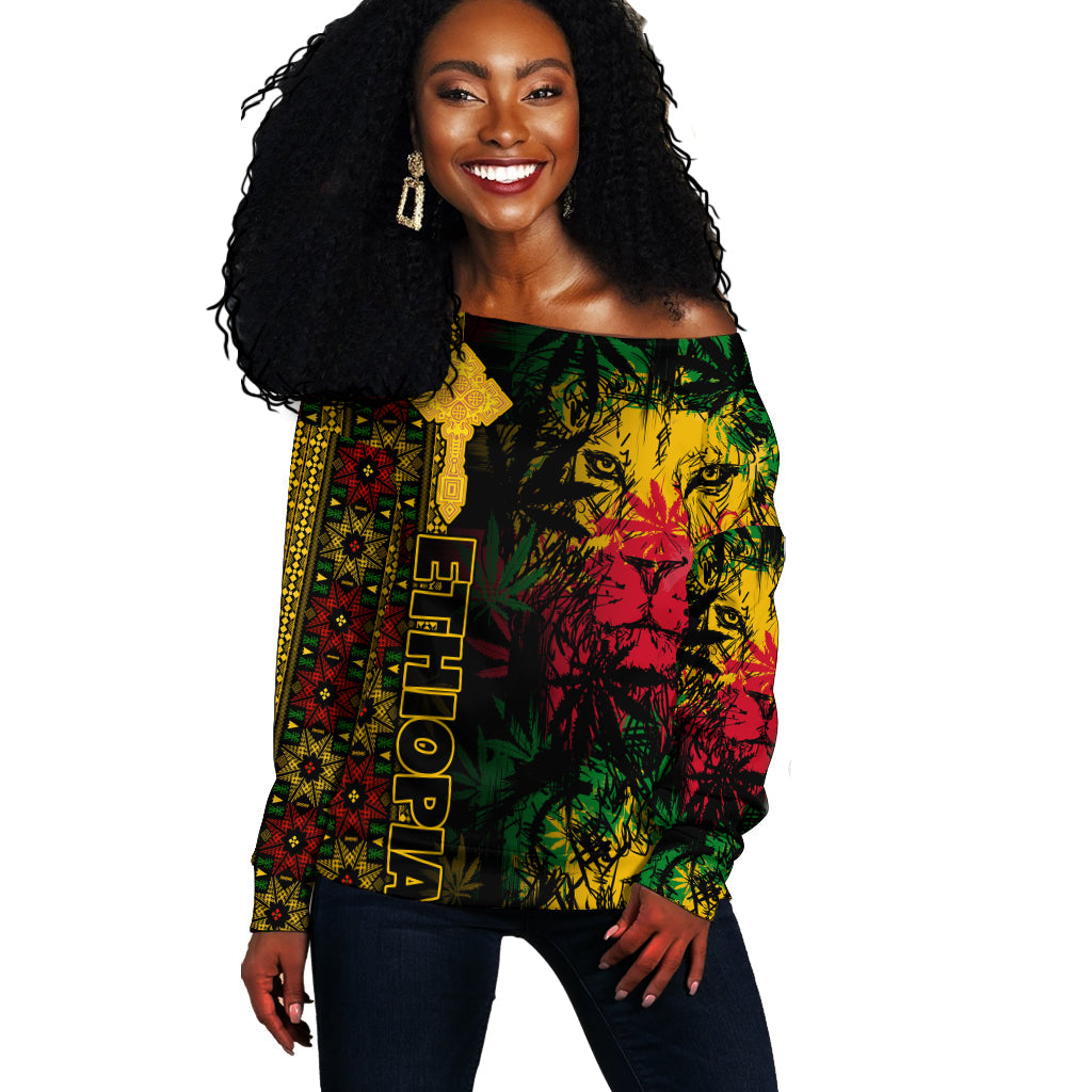Women’s off-shoulder reggae sweater, colorful lion and cross graphic, front view