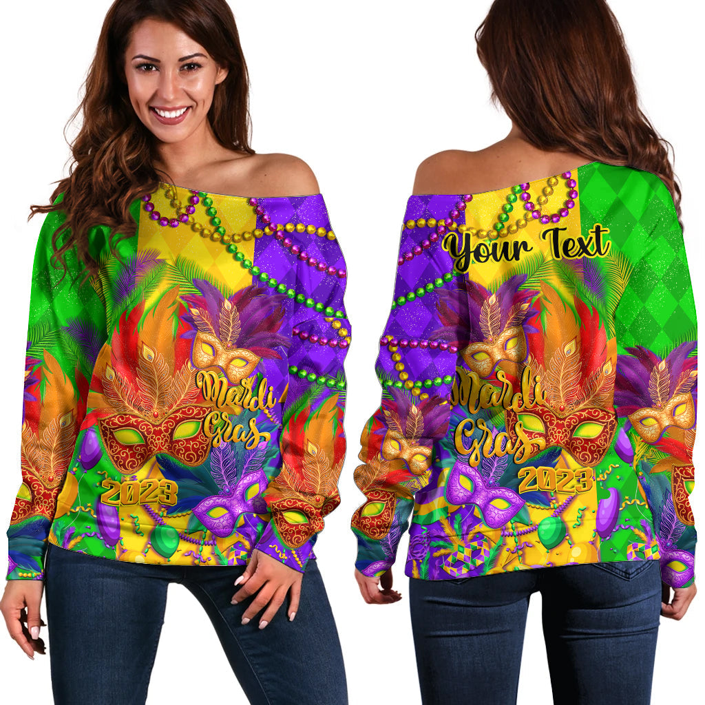 Off-shoulder sweater with colorful carnival mask and feather graphic, long sleeves