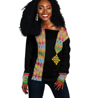 Black off-shoulder sweater for women with colorful patterned sleeves and gold emblem