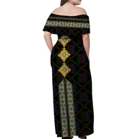 Off-shoulder long dress with black diamond-and-zigzag pattern and gold-toned center motif