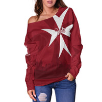 Red off-shoulder sweater with large white star and 'Malta' script on front