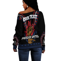 Black off-shoulder sweater back with Freedom United text and red/blue dashiki graphic