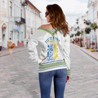 Women’s white off-shoulder sweater with back blue and yellow folk embroidery panel