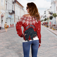 Women’s red off-shoulder Christmas sweater back view with snowflake print and cat graphic