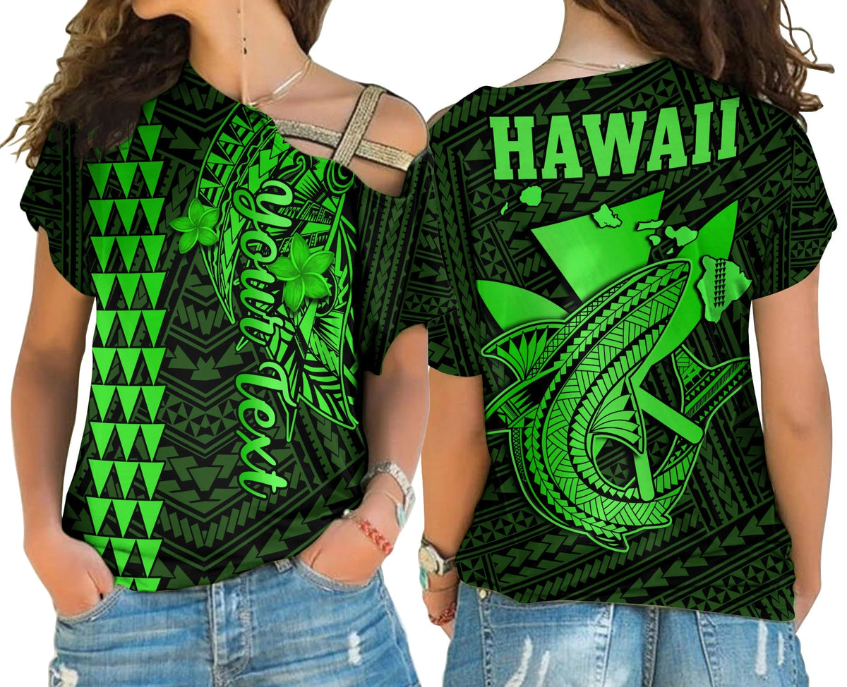 Green Hawaiian cross-shoulder shirt with bold tribal graphic and “HAWAII” on back