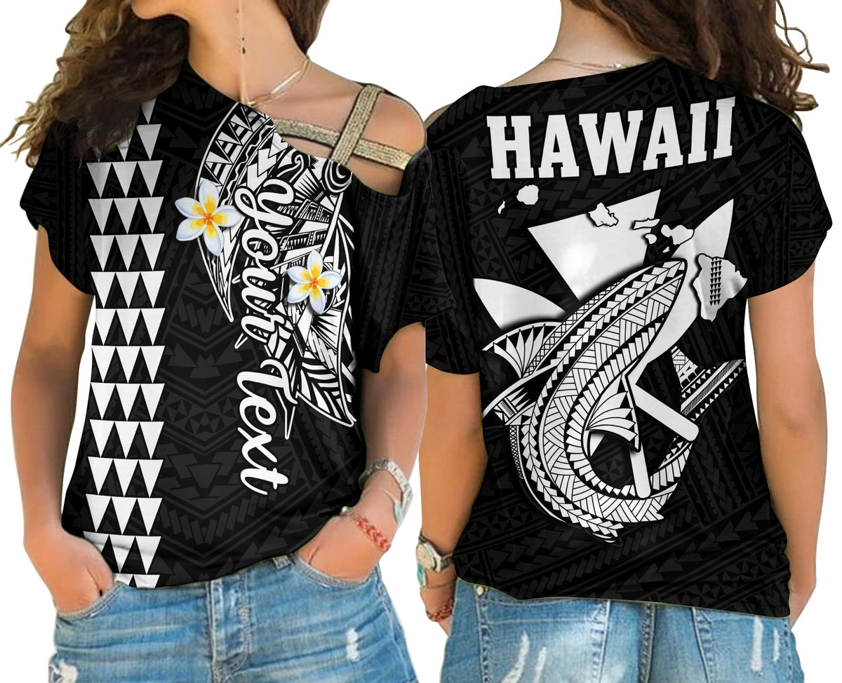 Black cold-shoulder cross top with Hawaii text and Polynesian shark graphic, women’s style