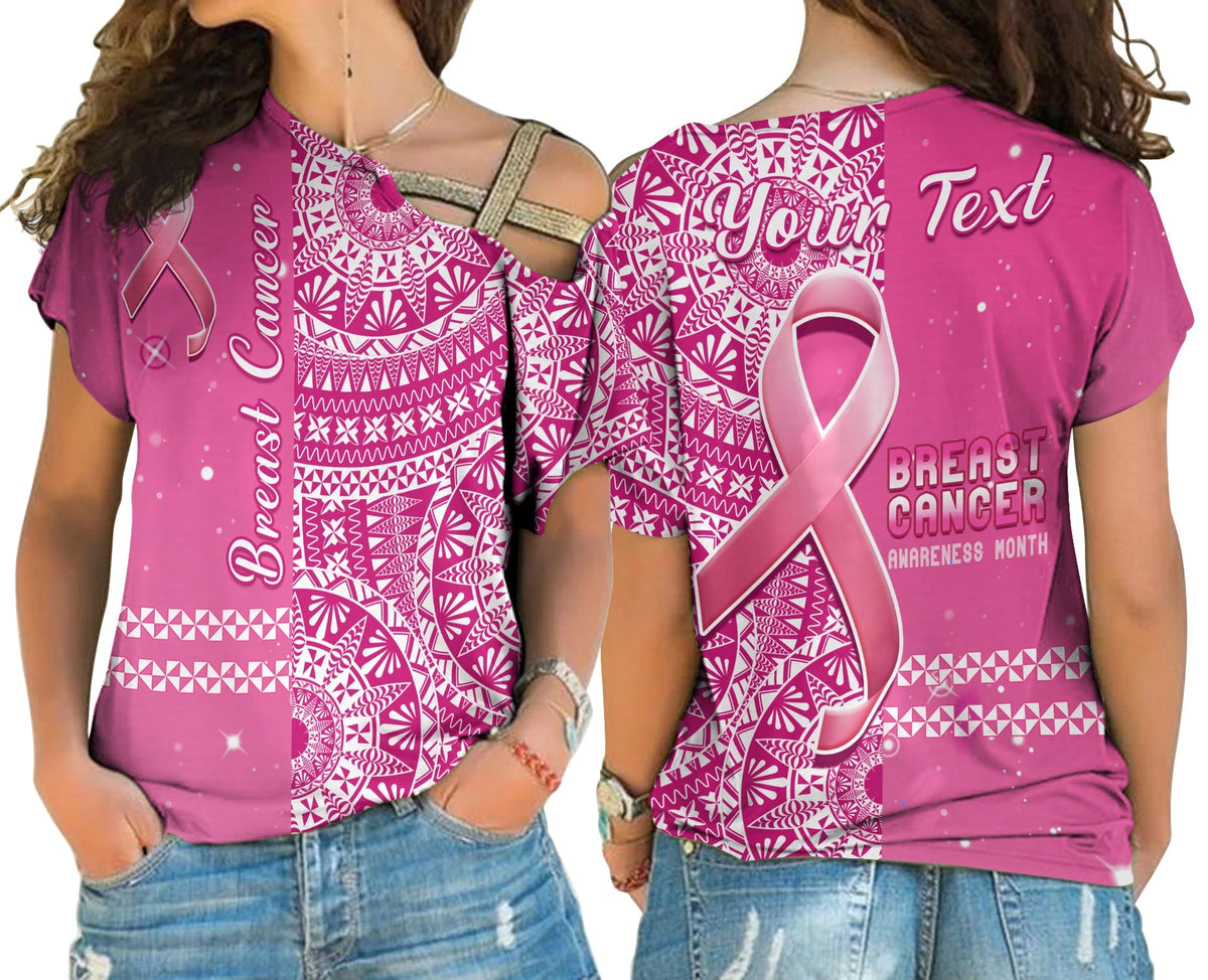 Pink cross-shoulder shirt with Tongan-style geometric print, breast cancer ribbon and text