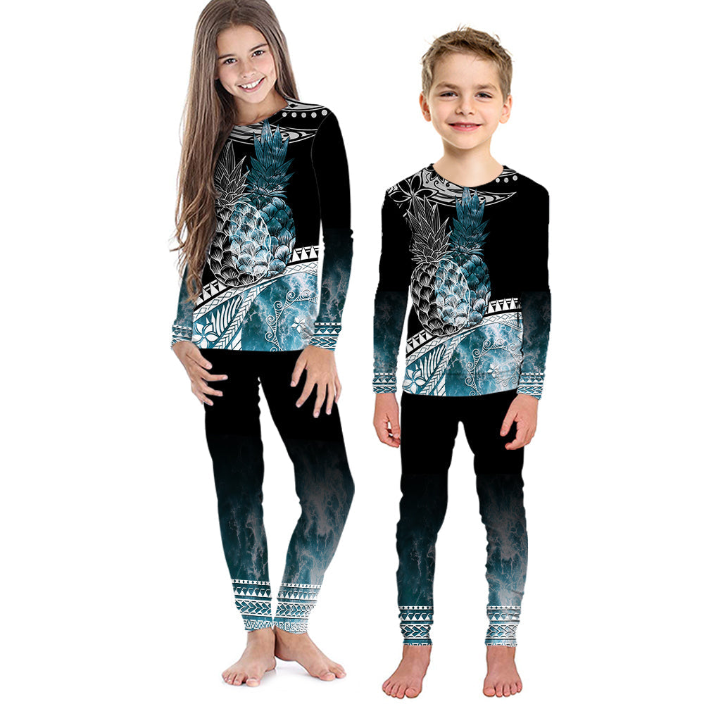 Kids black long-sleeve pajama set with teal ocean waves graphic and matching pants