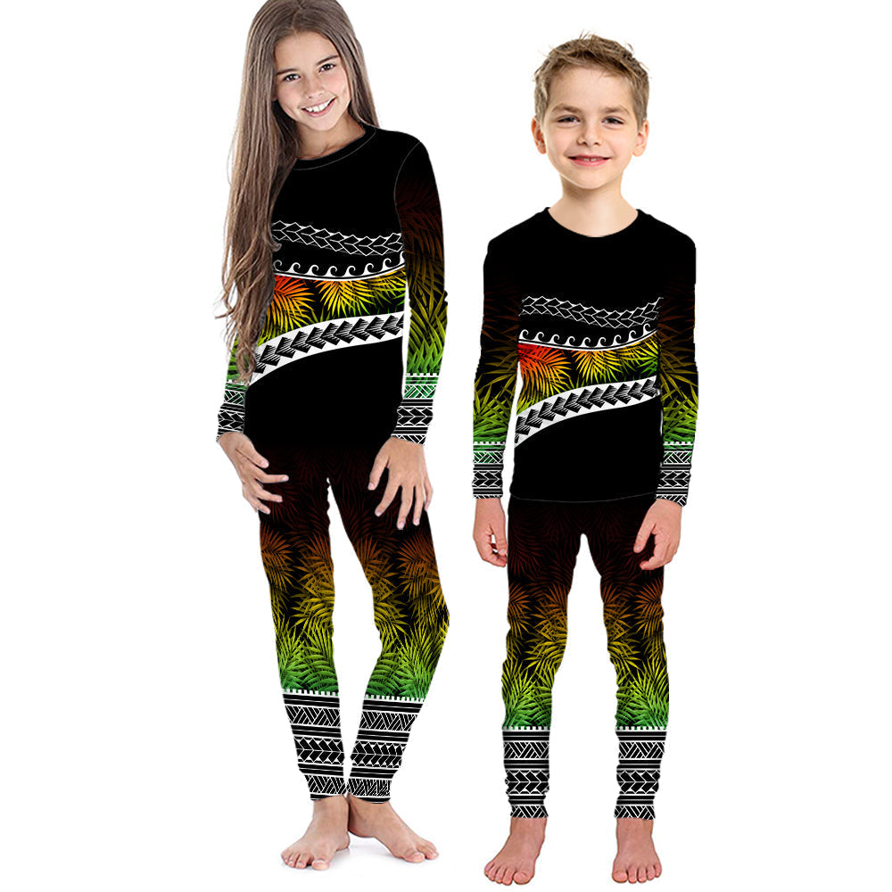 Kids long-sleeve pajama set with black, green and yellow Polynesian palm pattern.