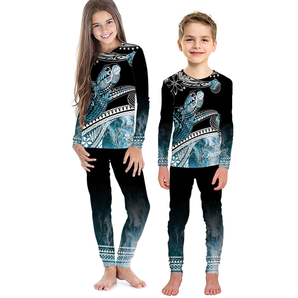 Kids’ black long-sleeve pajama set with teal turtle and ocean wave print pants