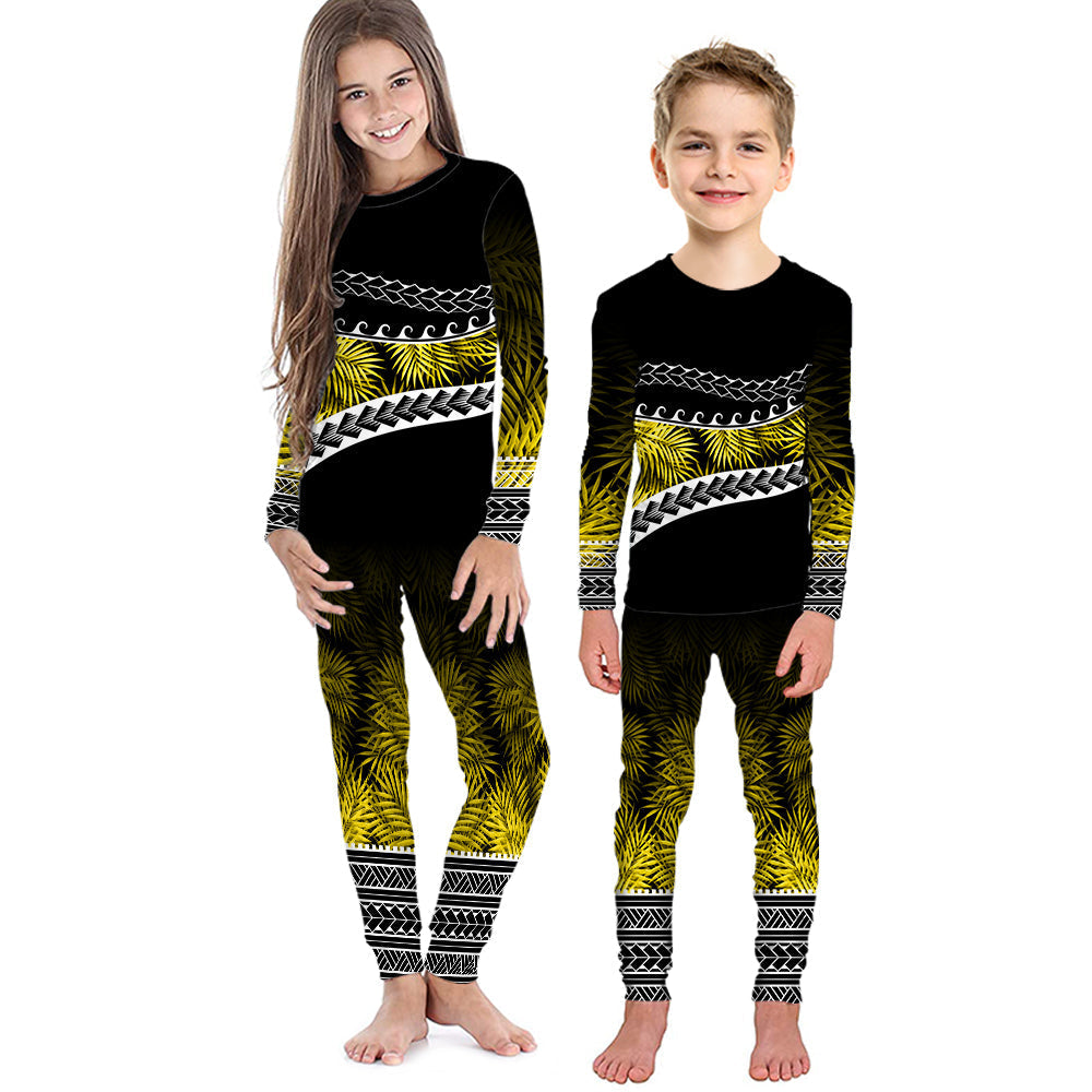 Kids long-sleeve pajama set with black top and pants, yellow-green palm pattern and trim