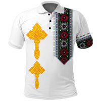 White polo shirt with yellow cross graphic and colorful patterned side stripe
