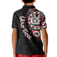 Back of kids black polo shirt with large Haida-style face and red/white artwork