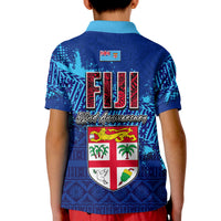 Kids blue polo shirt back with large Fiji text, shield crest, blue tribal patterns
