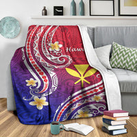 Folded Hawaiian blanket on gray sofa: red-to-purple-to-blue gradient with white scroll borders