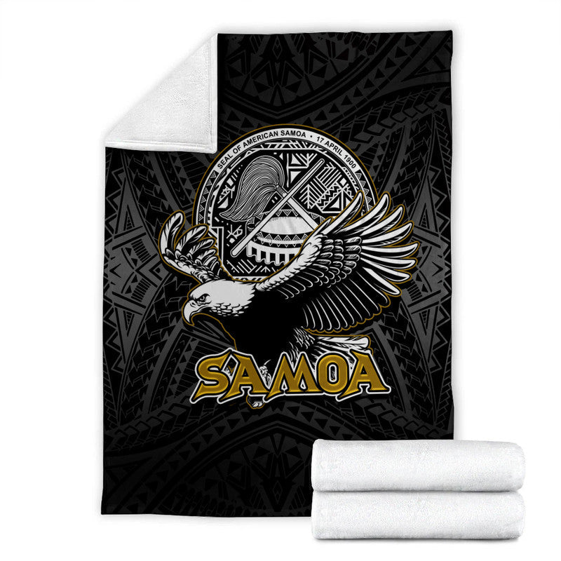 Black Samoa premium blanket with white seal medallion, eagle artwork, and “SAMOA” text; two rolled blankets.