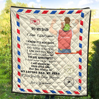 Beige quilt blanket with “My loving dad, my hero” wording and red/blue diamond edge