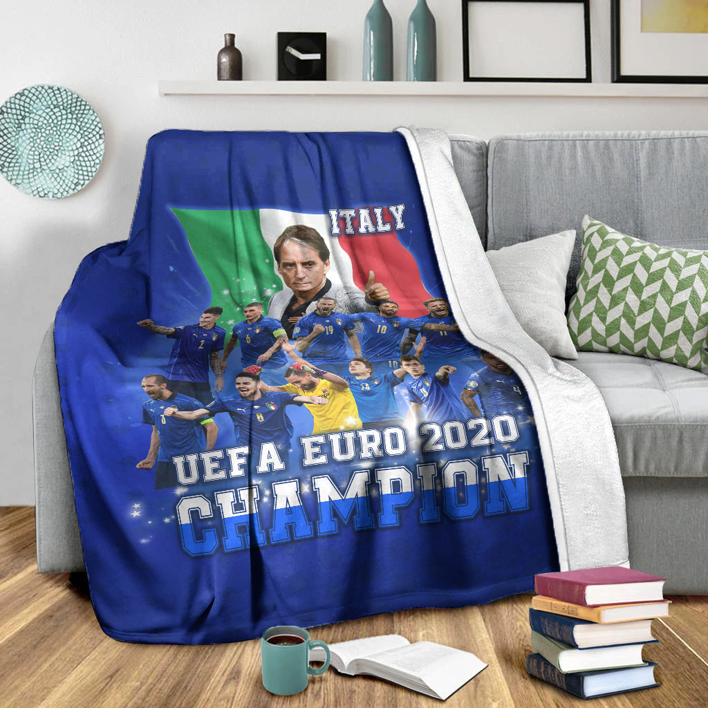 Blue Italy UEFA Euro 2020 Champions blanket on a gray sofa with white throw border