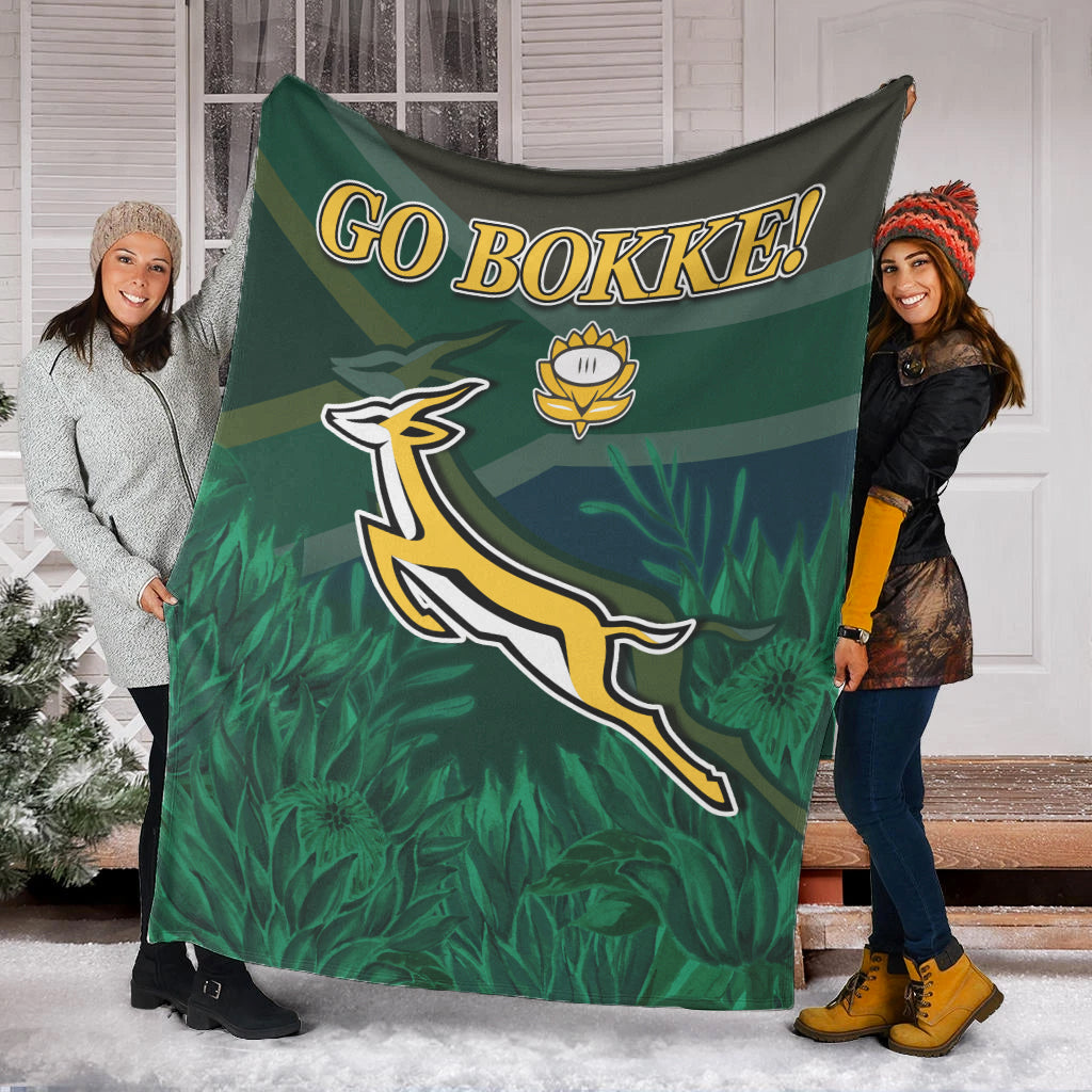 Green “GO BOKKE!” rugby blanket with Springbok emblem and protea flower details