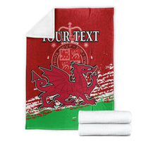 Folded Wales football blanket with 'YOUR TEXT', red upper panel, green lower panel, dragon